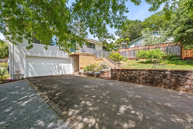 8940 Irving St, Graton, CA 95444 - view of front of house featuring asphalt driveway, stairway, a garage, and fence