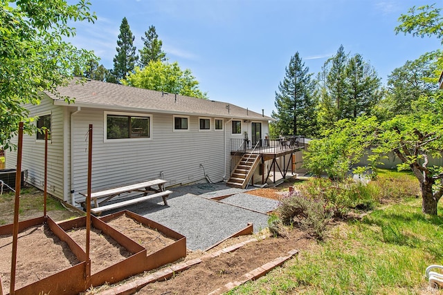 8940 Irving St, Graton, CA 95444 - rear view of property with stairs, a deck, a fenced backyard, a shingled roof, and a garden