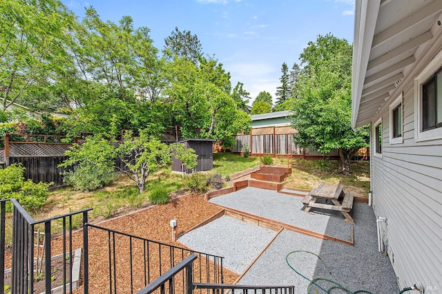 8940 Irving St, Graton, CA 95444 - view of patio featuring a fenced backyard, a shed, an outdoor structure, and a garden