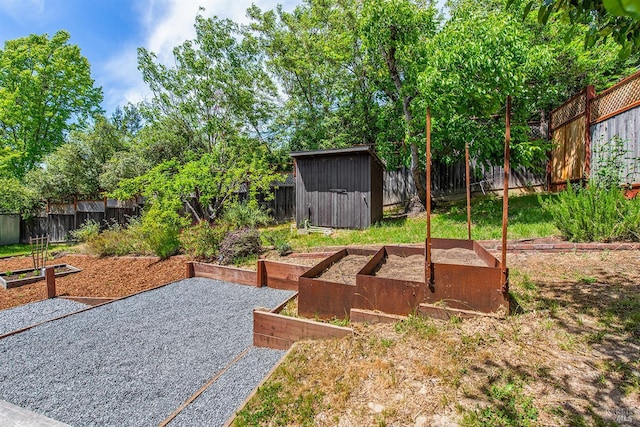 8940 Irving St, Graton, CA 95444 - fenced backyard with a vegetable garden, a storage unit, and an outdoor structure