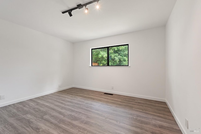8940 Irving St, Graton, CA 95444 - spare room with wood finished floors, baseboards, and track lighting