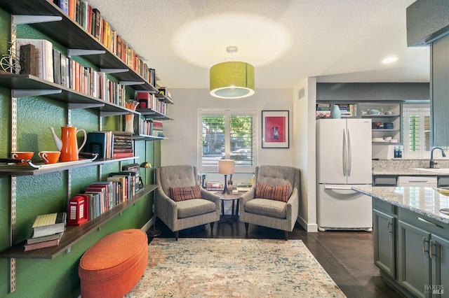 464 Azalea Way, Vacaville, CA 95688 - sitting room featuring dark wood finished floors, a textured ceiling, and baseboards