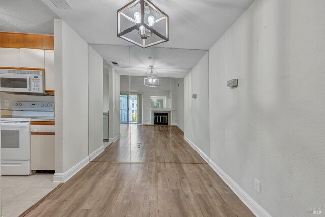 3183 Wayside Plz Unit 319, Walnut Creek, CA 94597 - hall with light wood-style floors, a chandelier, and baseboards