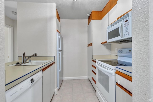 3183 Wayside Plz Unit 319, Walnut Creek, CA 94597 - kitchen with white appliances, a sink, white cabinets, baseboards, and light countertops