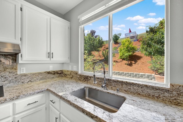 1917 Rollingwood Dr, Fairfield, CA 94534 - kitchen with a sink, white cabinetry, light stone countertops, and under cabinet range hood
