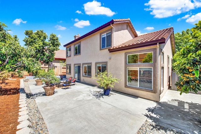 1917 Rollingwood Dr, Fairfield, CA 94534 - rear view of house featuring stucco siding, a patio, fence, and a tiled roof
