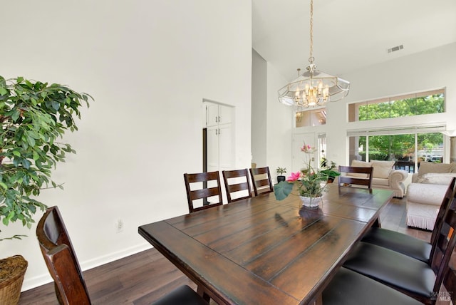 1917 Rollingwood Dr, Fairfield, CA 94534 - dining area with a towering ceiling, a chandelier, dark wood-style flooring, and baseboards