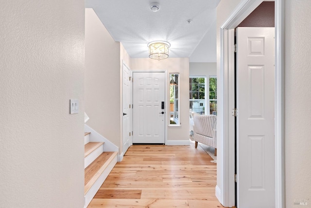 14 Ceriani Ct, Napa, CA 94558 - foyer entrance with light wood-type flooring, stairway, baseboards, a textured wall, and a chandelier
