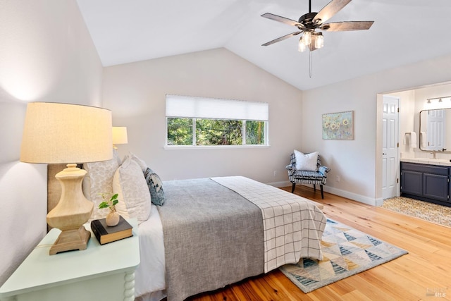 14 Ceriani Ct, Napa, CA 94558 - bedroom with wood finished floors, vaulted ceiling, ensuite bathroom, a sink, and baseboards