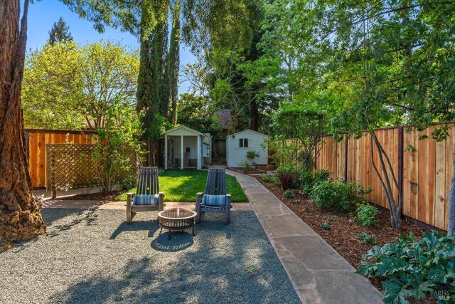 14 Ceriani Ct, Napa, CA 94558 - fenced backyard featuring a storage shed, a fire pit, and an outbuilding