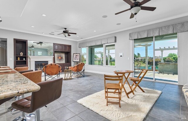 339 Desert Forest Ct, Rio Vista, CA 94571 - living area with a glass covered fireplace, ornamental molding, ceiling fan, recessed lighting, and light tile patterned flooring