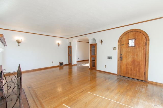 1124 Tuolumne St, Vallejo, CA 94590 - unfurnished living room featuring arched walkways, light wood finished floors, and baseboards