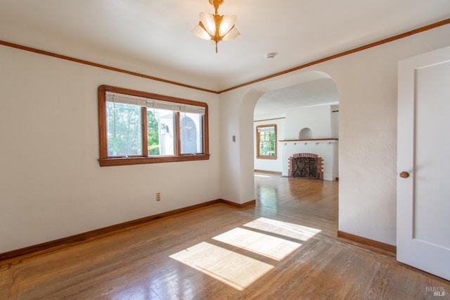 1124 Tuolumne St, Vallejo, CA 94590 - spare room featuring arched walkways, hardwood / wood-style flooring, baseboards, and ornamental molding