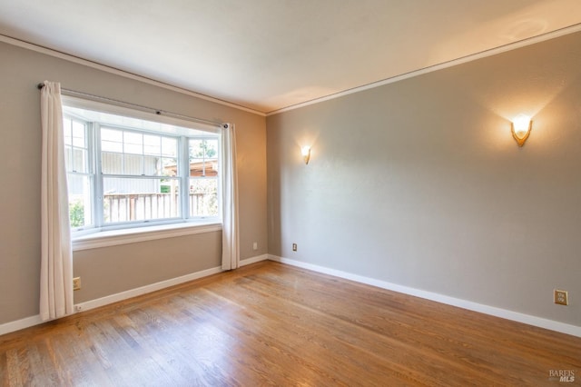 1124 Tuolumne St, Vallejo, CA 94590 - spare room with wood finished floors, baseboards, and crown molding