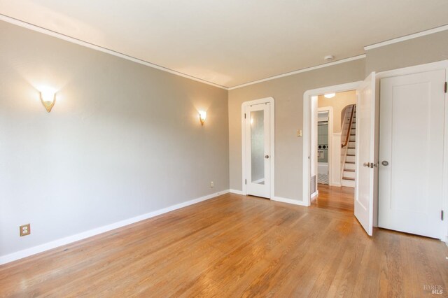 1124 Tuolumne St, Vallejo, CA 94590 - spare room featuring light wood-type flooring, crown molding, baseboards, and stairs