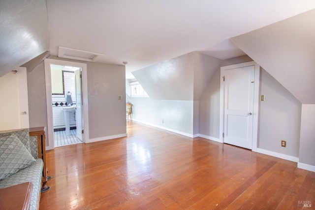 1124 Tuolumne St, Vallejo, CA 94590 - bonus room featuring wood finished floors, vaulted ceiling, baseboards, and attic access
