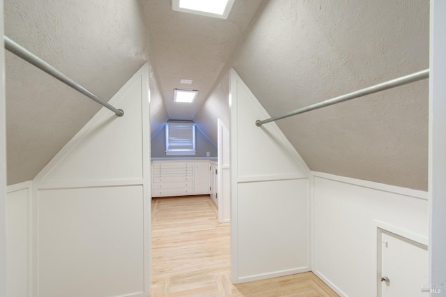 1124 Tuolumne St, Vallejo, CA 94590 - additional living space with light wood-style flooring, vaulted ceiling, and a decorative wall