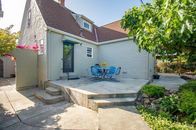 1124 Tuolumne St, Vallejo, CA 94590 - back of house featuring stucco siding, roof with shingles, a patio area, and a chimney