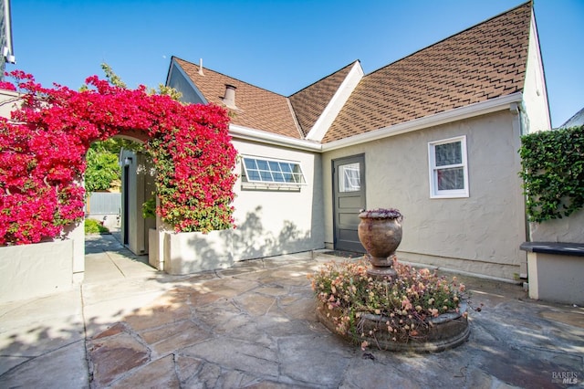 1124 Tuolumne St, Vallejo, CA 94590 - view of front of house featuring stucco siding, a patio, and roof with shingles