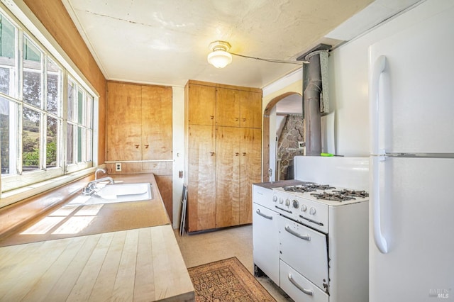 1561 S Fitch Mountain Rd, Healdsburg, CA 95448 - kitchen featuring a sink, freestanding refrigerator, arched walkways, and light countertops