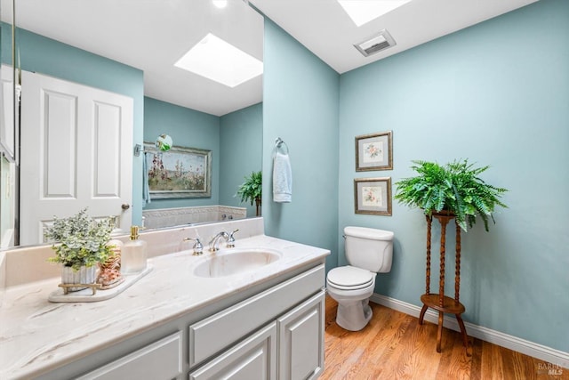 286 Monte Vista Dr, Napa, CA 94559 - bathroom featuring a skylight, toilet, wood finished floors, vanity, and baseboards