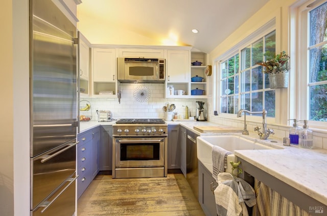 17 Oak Rd, Larkspur, CA 94939 - kitchen with high end appliances, light stone counters, backsplash, open shelves, and white cabinetry