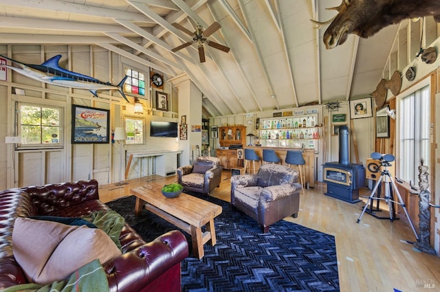 17 Oak Rd, Larkspur, CA 94939 - living area with hardwood / wood-style floors, a wood stove, a ceiling fan, and wooden walls