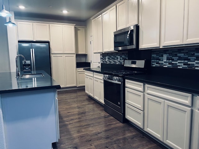 2560 Greg Jarvis Ave, Sacramento, CA 95834 - kitchen with range with gas stovetop, stainless steel microwave, refrigerator with ice dispenser, dark countertops, and a sink