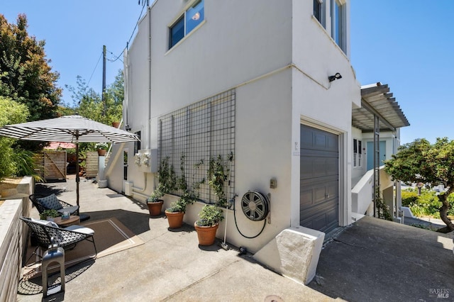 503 Easterby St, Sausalito, CA 94965 - view of patio featuring an attached garage and asphalt driveway