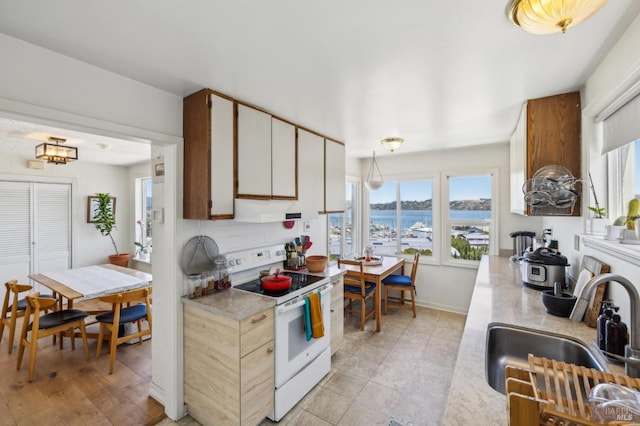 503 Easterby St, Sausalito, CA 94965 - kitchen with white range with electric stovetop, a sink, light countertops, and a water view