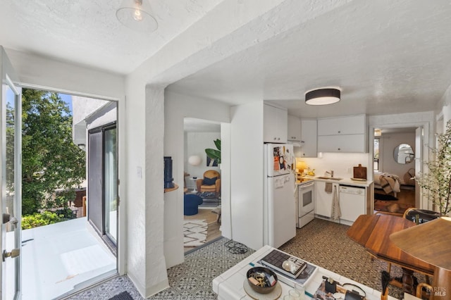 503 Easterby St, Sausalito, CA 94965 - kitchen featuring white appliances, white cabinetry, light countertops, a sink, and a textured ceiling