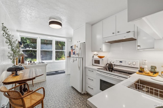 503 Easterby St, Sausalito, CA 94965 - kitchen with white appliances, under cabinet range hood, light countertops, white cabinetry, and light flooring