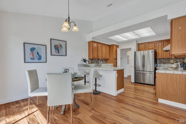 63 Brighton Dr, Vallejo, CA 94591 - dining area with light wood-style flooring, a chandelier, and baseboards