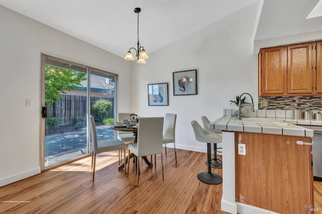 63 Brighton Dr, Vallejo, CA 94591 - dining space featuring lofted ceiling, light wood-style floors, baseboards, and a chandelier