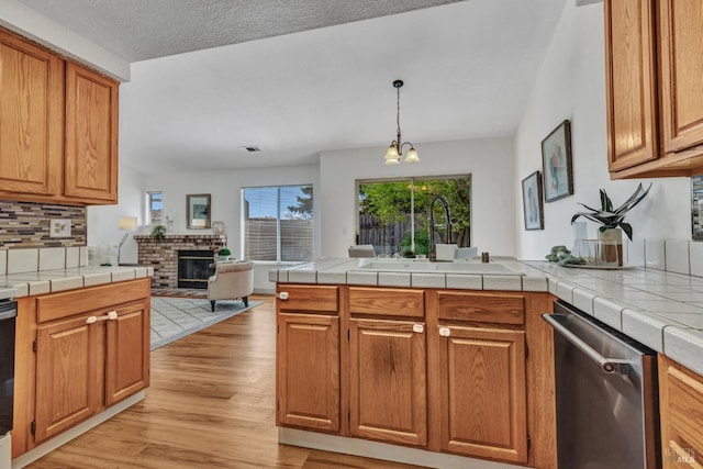 63 Brighton Dr, Vallejo, CA 94591 - kitchen featuring dishwasher, a sink, a peninsula, open floor plan, and light wood-type flooring