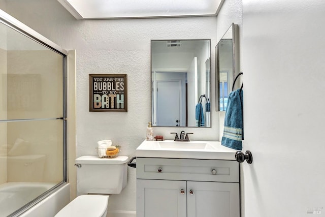 63 Brighton Dr, Vallejo, CA 94591 - bathroom with vanity, toilet, a textured wall, and bath / shower combo with glass door