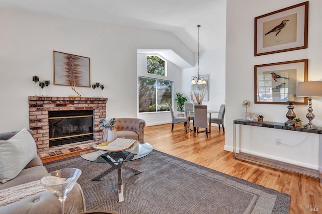 63 Brighton Dr, Vallejo, CA 94591 - living area with wood finished floors, a chandelier, a brick fireplace, high vaulted ceiling, and baseboards