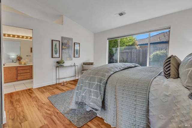 63 Brighton Dr, Vallejo, CA 94591 - bedroom featuring lofted ceiling, light wood-style floors, ensuite bath, and baseboards