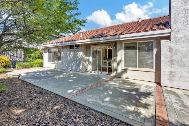 63 Brighton Dr, Vallejo, CA 94591 - rear view of house featuring stucco siding, a tile roof, and a patio area