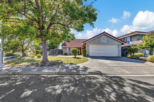 63 Brighton Dr, Vallejo, CA 94591 - view of front of house with a garage, a tiled roof, driveway, and stucco siding