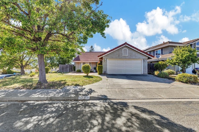 63 Brighton Dr, Vallejo, CA 94591 - view of front facade featuring a garage, a tile roof, driveway, and stucco siding