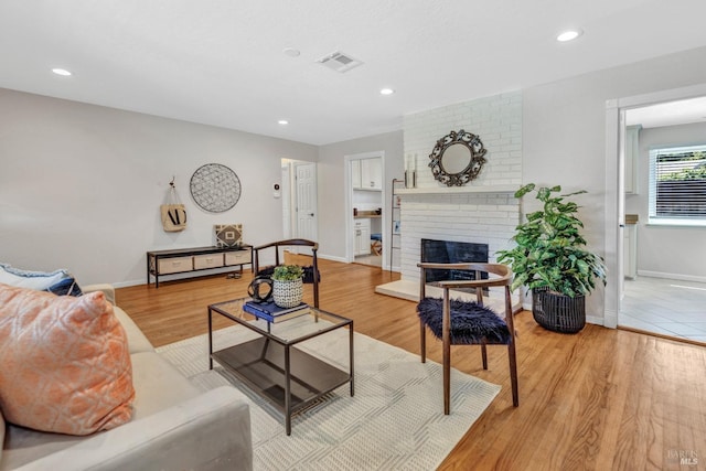 168 Bergwall Way, Vallejo, CA 94591 - living area featuring light wood finished floors, a brick fireplace, and recessed lighting