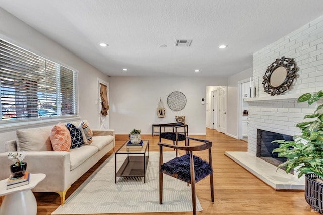 168 Bergwall Way, Vallejo, CA 94591 - living room with recessed lighting, light wood-type flooring, a fireplace, and a textured ceiling