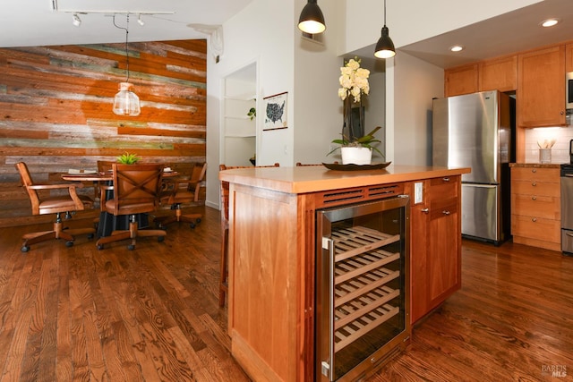 1006 Birkdale Dr, Napa, CA 94559 - indoor dry bar with freestanding refrigerator, wine cooler, wood walls, dark wood-type flooring, and hanging light fixtures