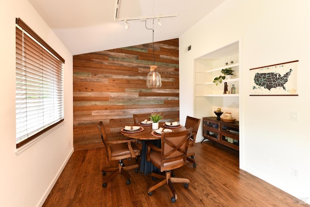 1006 Birkdale Dr, Napa, CA 94559 - dining space with lofted ceiling, wooden walls, rail lighting, wood finished floors, and baseboards