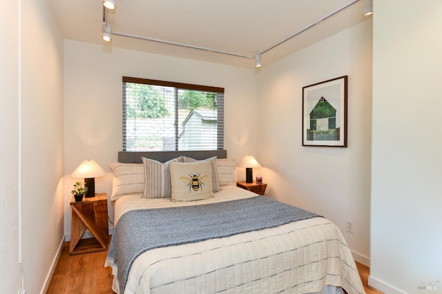 1006 Birkdale Dr, Napa, CA 94559 - bedroom with rail lighting, wood finished floors, and baseboards