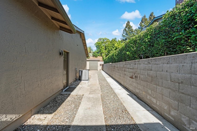 1006 Birkdale Dr, Napa, CA 94559 - view of side of home featuring stucco siding, central air condition unit, and fence