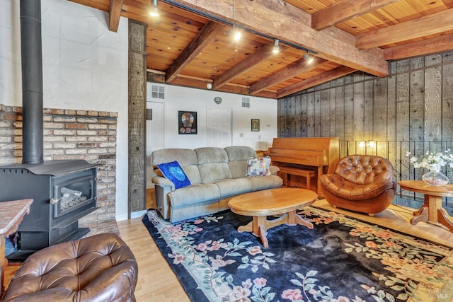 1324 Delwood St, Vallejo, CA 94591 - living room featuring wood ceiling, beamed ceiling, wood finished floors, a wood stove, and wooden walls