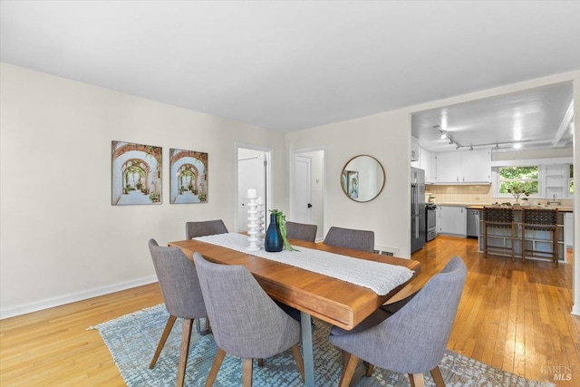 2787 N Fitch Mountain Rd, Healdsburg, CA 95448 - dining space featuring light wood-style flooring, baseboards, and rail lighting