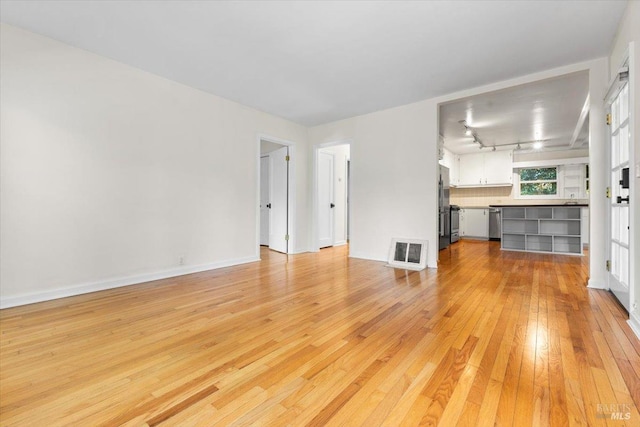 2787 N Fitch Mountain Rd, Healdsburg, CA 95448 - unfurnished living room with light wood-style floors and baseboards